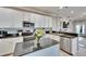 Bright kitchen with white cabinets, black countertops, and stainless steel appliances at 1220 Emerald Hill Way, Valrico, FL 33594