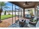 Relax in this enclosed lanai with brick floors, a ceiling fan, and views of the yard and greenery at 1220 Emerald Hill Way, Valrico, FL 33594