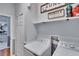 Bright laundry room featuring modern appliances, shelving, and ample storage, creating a functional and organized space at 1220 Emerald Hill Way, Valrico, FL 33594