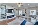 Cozy living room with a fireplace, hardwood floors, and built-in shelves, designed for both comfort and style at 1220 Emerald Hill Way, Valrico, FL 33594