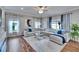 Bright, spacious living room with hardwood floors, large windows, and modern decor, perfect for relaxation and entertaining at 1220 Emerald Hill Way, Valrico, FL 33594