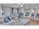 Inviting living room with hardwood floors, a comfortable sectional, and plenty of natural light, creating a cozy space at 1220 Emerald Hill Way, Valrico, FL 33594