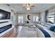 Cozy living room featuring hardwood floors, a fireplace, and ample natural light, offering a comfortable and stylish living space at 1220 Emerald Hill Way, Valrico, FL 33594