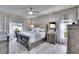 Serene main bedroom features a plush bed, elegant decor, and natural light from the window at 1220 Emerald Hill Way, Valrico, FL 33594