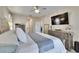 Comfortable main bedroom features soft lighting, ceiling fan and dresser with decorative mirror at 1220 Emerald Hill Way, Valrico, FL 33594