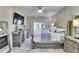 This main bedroom has a ceiling fan, large television, and carpet at 1220 Emerald Hill Way, Valrico, FL 33594