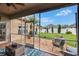 The screened-in patio features a blue rug and overlooks the spacious backyard at 1220 Emerald Hill Way, Valrico, FL 33594