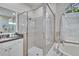 Shower with glass door, tiled wall, and shower head at 1220 Emerald Hill Way, Valrico, FL 33594