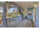 Charming back porch with wood flooring and railing, offering serene outdoor views at 12227 Noreast Lake Dr, Tampa, FL 33612