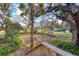 Picturesque backyard featuring mature trees, a storage shed, and lush greenery, from a deck at 12227 Noreast Lake Dr, Tampa, FL 33612