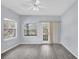 Bedroom with two windows and a sliding door to balcony at 12227 Noreast Lake Dr, Tampa, FL 33612