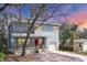 Inviting two-story home with blue siding, a charming front porch, well-maintained landscaping, and a convenient driveway at 12227 Noreast Lake Dr, Tampa, FL 33612