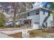 Quaint two-story house featuring blue siding, a cozy front porch, and a well-maintained yard at 12227 Noreast Lake Dr, Tampa, FL 33612