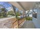 Inviting front porch featuring a classic wooden railing, and an open view of the neighborhood street at 12227 Noreast Lake Dr, Tampa, FL 33612