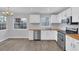 Cozy eat-in kitchen with white cabinets, butcher block counters, stainless steel appliances, and natural light at 12227 Noreast Lake Dr, Tampa, FL 33612