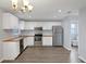 Beautiful kitchen with stainless steel appliances, butcher block countertops, and white cabinets at 12227 Noreast Lake Dr, Tampa, FL 33612