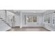 Light-filled living room with hardwood floors, large windows, and a staircase at 12227 Noreast Lake Dr, Tampa, FL 33612