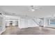 Inviting open concept living room adjoining the kitchen and staircase with modern finishes at 12227 Noreast Lake Dr, Tampa, FL 33612