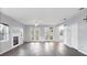 Bright living room featuring hardwood floors, fireplace, French doors, and ample natural light at 12227 Noreast Lake Dr, Tampa, FL 33612