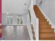 Open-concept living area with hardwood floors, staircase, and natural light from the glass panel doors at 12227 Noreast Lake Dr, Tampa, FL 33612