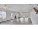 Spacious living room with hardwood floors, ceiling fans, a fireplace, and glass panel doors at 12227 Noreast Lake Dr, Tampa, FL 33612