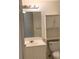 Standard bathroom featuring a single sink vanity and overhead storage at 12403 Hibiscus Oak Pl # 202, Tampa, FL 33612