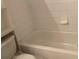 A bathtub with tile surround offers a place to relax and refresh at 12403 Hibiscus Oak Pl # 202, Tampa, FL 33612