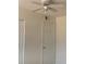 Bedroom with ceiling fan, white walls and a white door at 12403 Hibiscus Oak Pl # 202, Tampa, FL 33612
