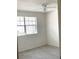 Bedroom with a window, light gray floors, and white walls at 12403 Hibiscus Oak Pl # 202, Tampa, FL 33612