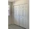 Bedroom features a closet with bi-fold doors and gray floors at 12403 Hibiscus Oak Pl # 202, Tampa, FL 33612