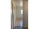 Tiled hallway leading to the back door with a closet on the left at 12403 Hibiscus Oak Pl # 202, Tampa, FL 33612