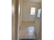 Hallway leading to kitchen with tile flooring at 12403 Hibiscus Oak Pl # 202, Tampa, FL 33612