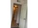 Hallway showing a view of a well-lit bathroom with tile floors at 12403 Hibiscus Oak Pl # 202, Tampa, FL 33612