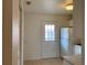 Cozy kitchen with tile floors, white appliances, and a door to the outside at 12403 Hibiscus Oak Pl # 202, Tampa, FL 33612