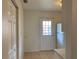 Tiled kitchen with closet and back door, ample counter space, and a refrigerator at 12403 Hibiscus Oak Pl # 202, Tampa, FL 33612