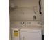White washer and dryer with white wire shelving at 12403 Hibiscus Oak Pl # 202, Tampa, FL 33612
