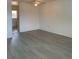 Bright living room with light gray wood flooring and ceiling fan at 12403 Hibiscus Oak Pl # 202, Tampa, FL 33612