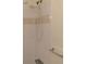 Close-up of a shower featuring adjustable shower head and tiled walls at 12403 Hibiscus Oak Pl # 202, Tampa, FL 33612