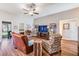 Bright living room featuring wood floors, large windows, and comfortable seating at 13134 Precept Way, Hudson, FL 34669