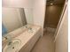 Bathroom features a double vanity sink, and a shower and tub at 13304 Meadowwood Ct, Tampa, FL 33618
