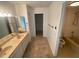 Bathroom featuring double sink vanity, neutral walls, and a separate tub and shower area at 13304 Meadowwood Ct, Tampa, FL 33618