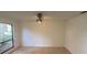 Bedroom with neutral carpeting, large window, and ceiling fan with light fixture at 13304 Meadowwood Ct, Tampa, FL 33618