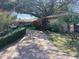 Attractive home with brick driveway, lush landscaping, and mature trees offering a welcoming atmosphere at 13304 Meadowwood Ct, Tampa, FL 33618