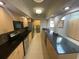 Open kitchen design with a large granite countertop, stainless steel appliances and tiled floor at 13304 Meadowwood Ct, Tampa, FL 33618