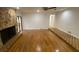 Spacious living room featuring wood floors, stone fireplace, and ample natural light at 13304 Meadowwood Ct, Tampa, FL 33618