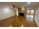Spacious living room featuring hardwood floors and a stone fireplace at 13304 Meadowwood Ct, Tampa, FL 33618