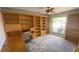 Office space featuring built-in bookshelves and a large window with a view of the landscape at 13304 Meadowwood Ct, Tampa, FL 33618