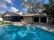 Beautiful in-ground pool with clear blue water and poolside patio for relaxing and entertaining at 13304 Meadowwood Ct, Tampa, FL 33618