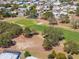 Scenic aerial of a golf course community boasting manicured greens, mature trees, and peaceful residential area at 14311 Action St, Brooksville, FL 34613