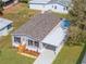 An aerial view of a charming single-story home with a carport and landscaped front yard at 14311 Action St, Brooksville, FL 34613